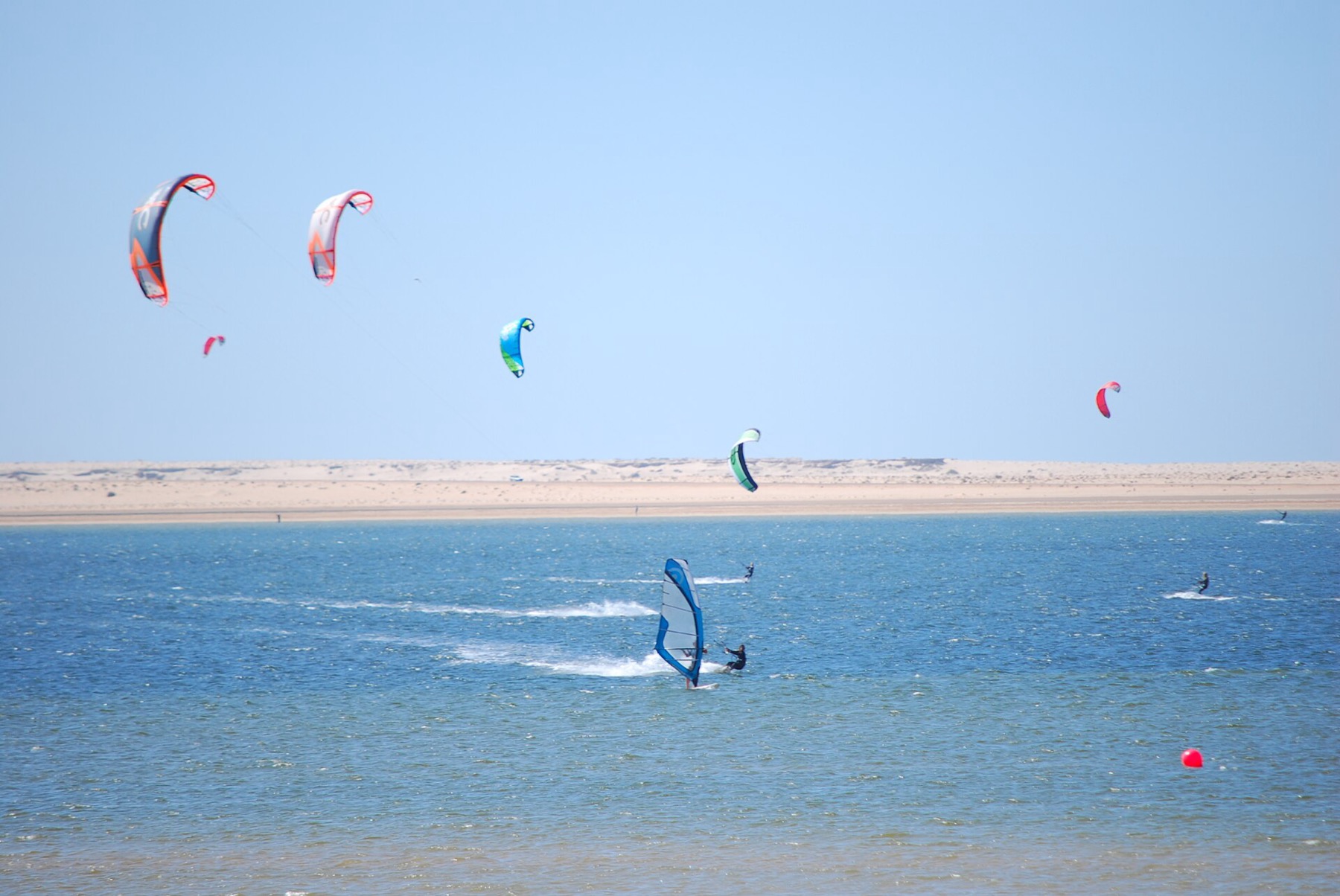 Kites and riders on Dakhla Lagoon in Morocco